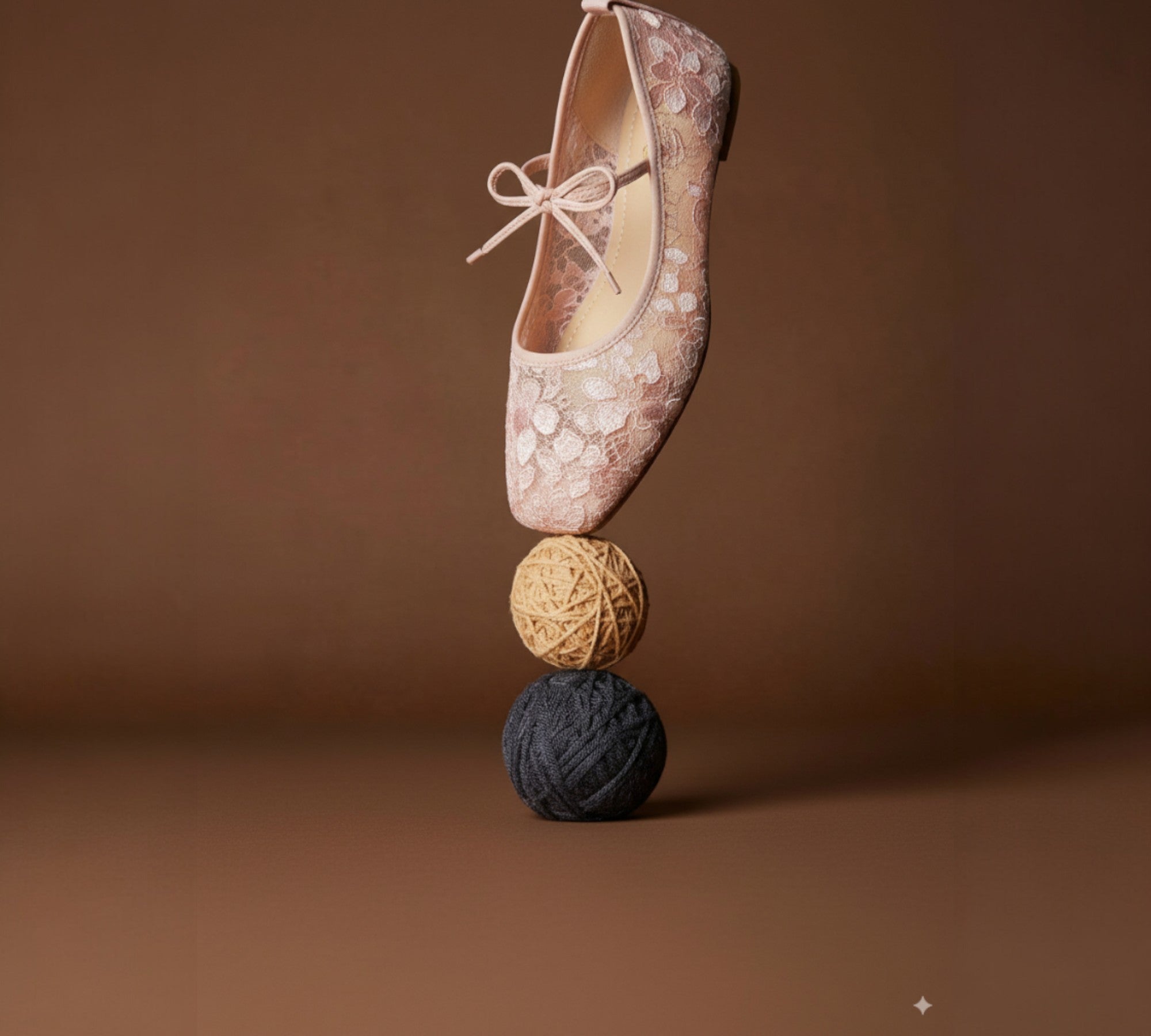 Floral-patterned shoe balanced on three textured balls against a brown background