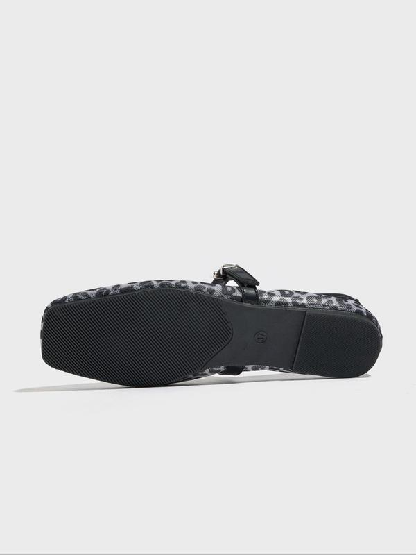 Black and white patterned sandal on a light gray background