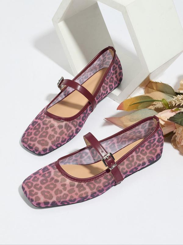 Pair of leopard print shoes with a strap on a white background