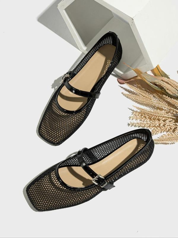 Black mesh shoes with buckles on a white background