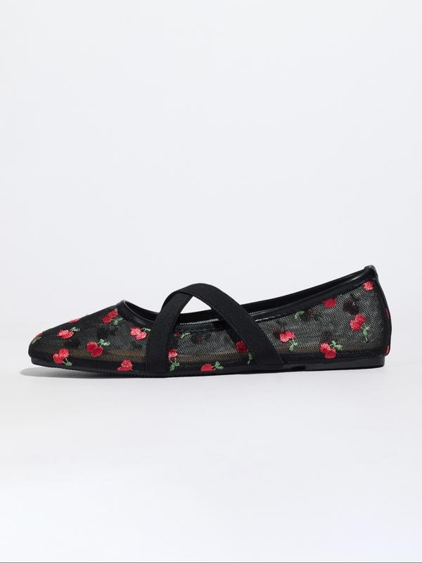 Black flat shoe with floral pattern on a white background