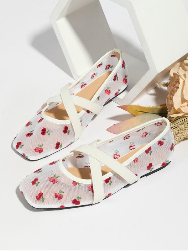 Floral print shoes with white straps on a light background