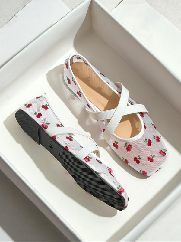 White shoes with red floral pattern on a white background