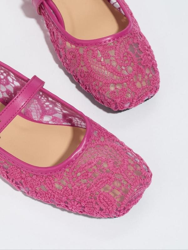 Pink lace shoes on a white background