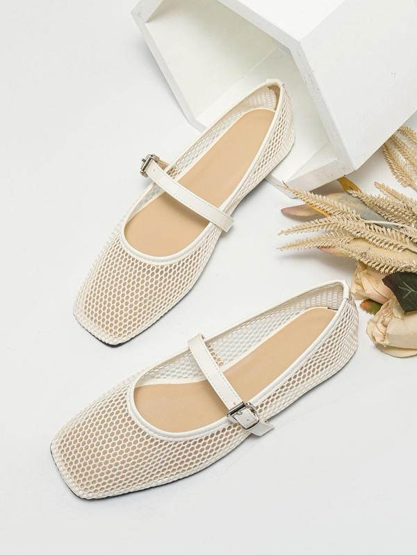 Pair of beige mesh shoes with a strap on a light gray background
