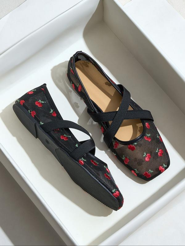 Black flats with red floral pattern on a white background