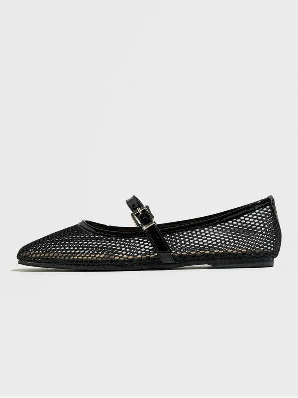 Black mesh flat shoe with a buckle on a light gray background