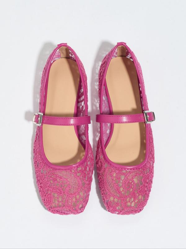 Pair of pink lace shoes with a strap on a white background