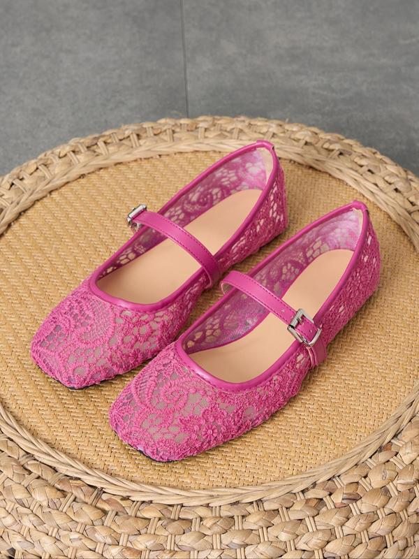 Pink lace shoes on a woven mat with a gray background