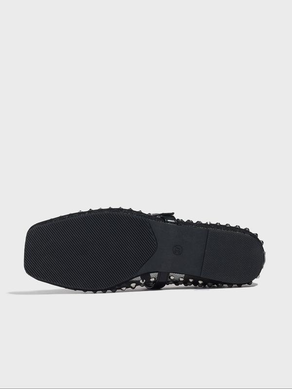 Black shoe sole on a light gray background